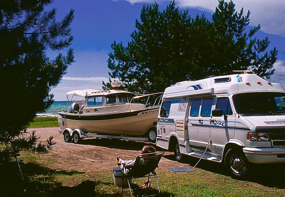 a class B van towing a boat