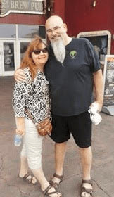 a man and woman with their arms around one another