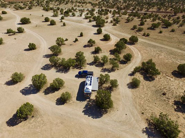 an Airstream boondocking in a pinyon juniper forest