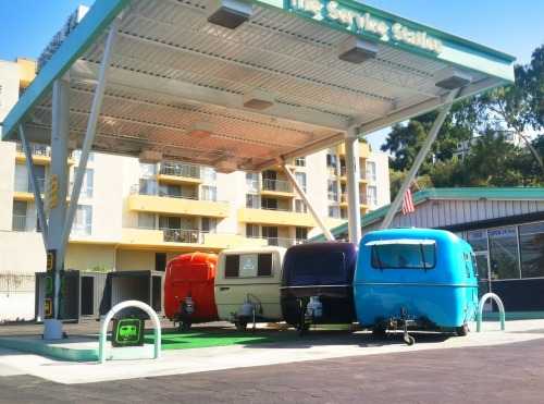 Uhaul CT, Trillium, and two Boler trailers parked at a rental facility that looks like a vintage gas station