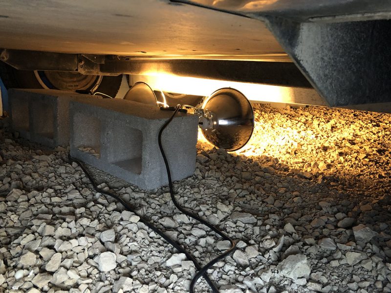Clamped lamps set up underneath an RV