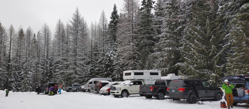 Truck camper parked in a ski resort parking lot