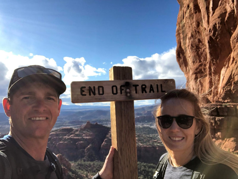 Britt & Drew next to a sign that says end of trail