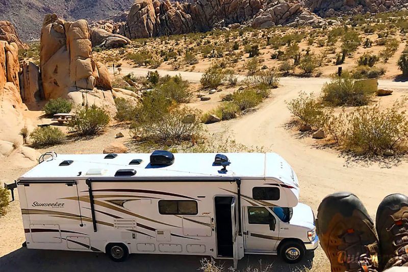 An RV with some boots in the right corner