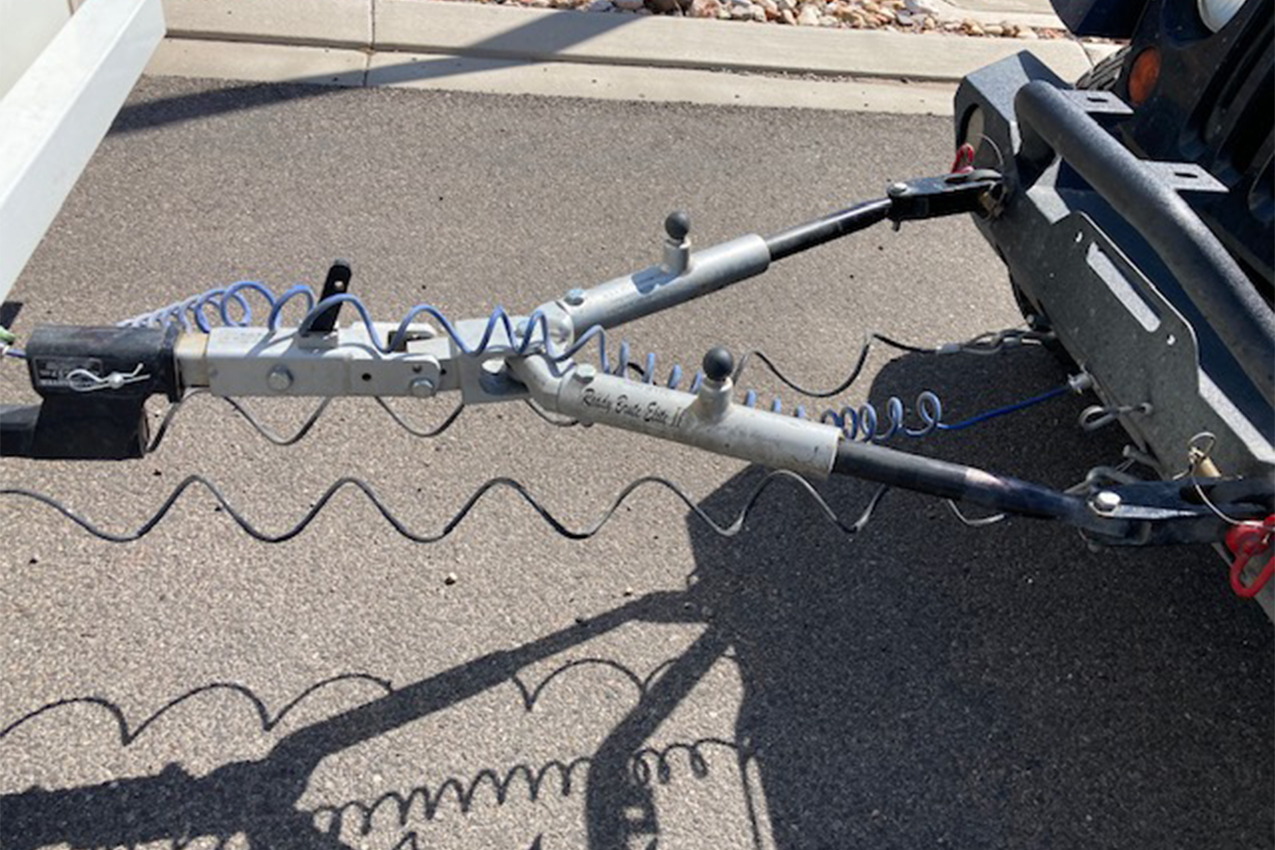 Tow bar attached to a car and RV
