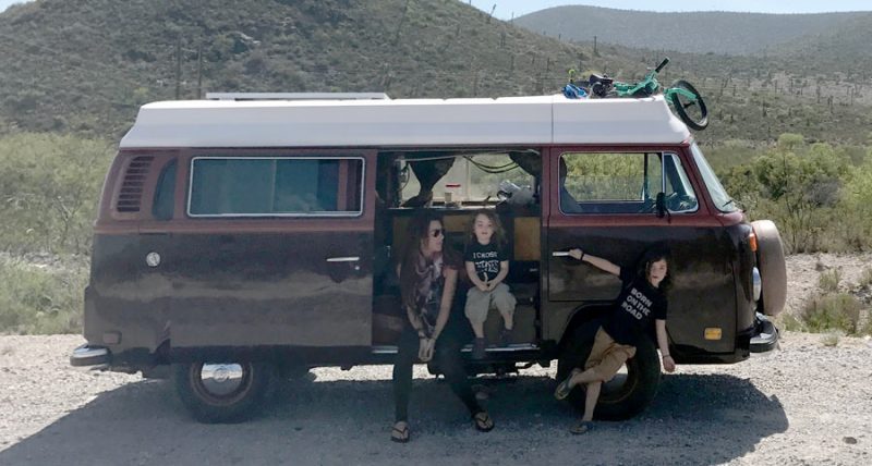 a mom and two of her boys in a VW bus