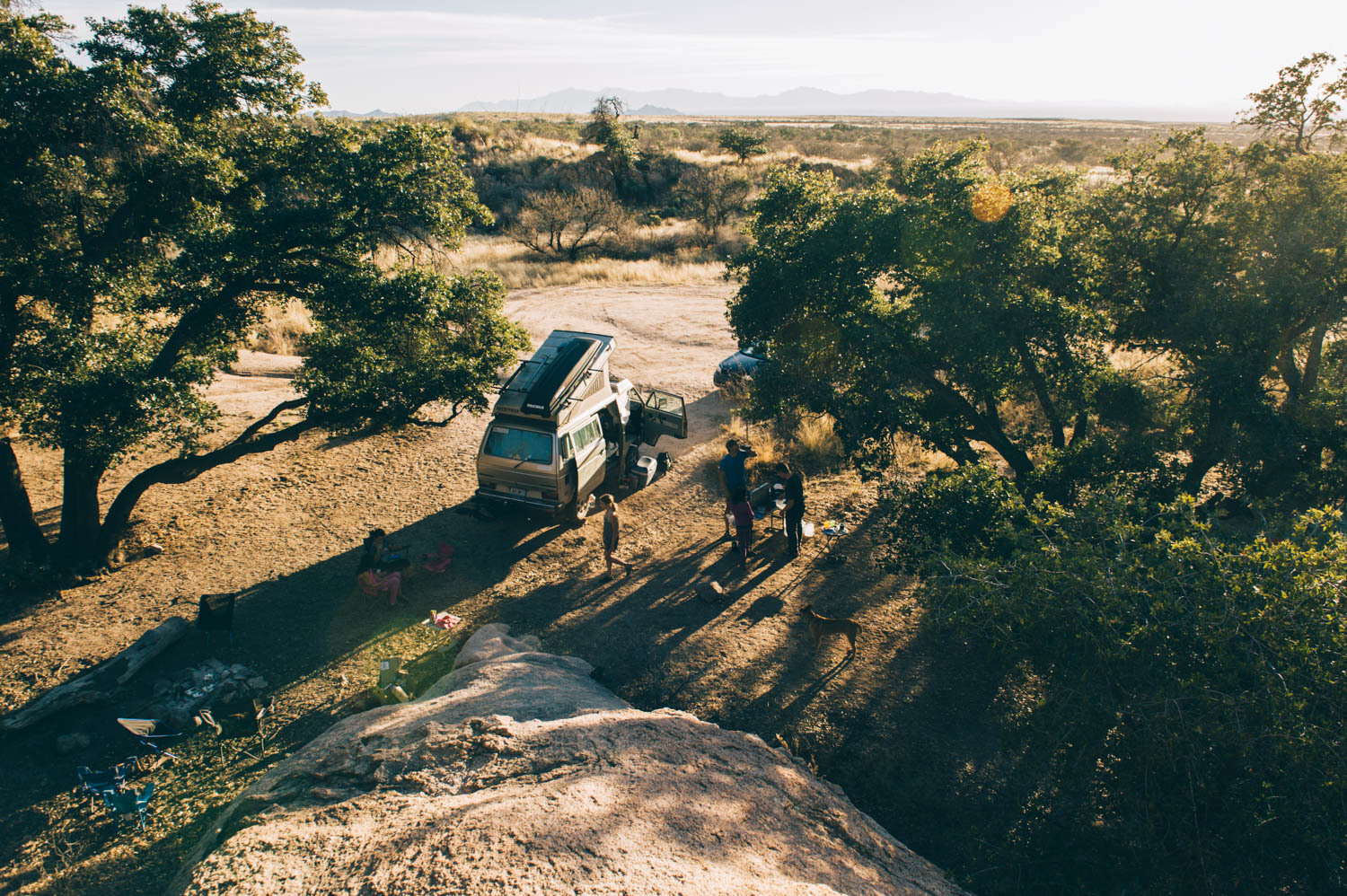 People standing next to a parked Westy.