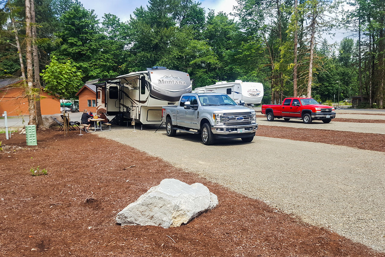 Two RVs parked in large RV spots.
