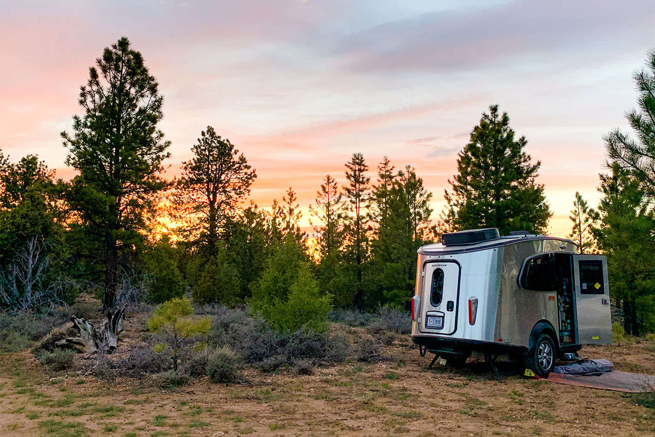 Airstream Basecamp parked in the desert sunset.