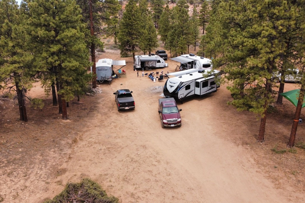 Several RVs parked in a circle in the high desert.