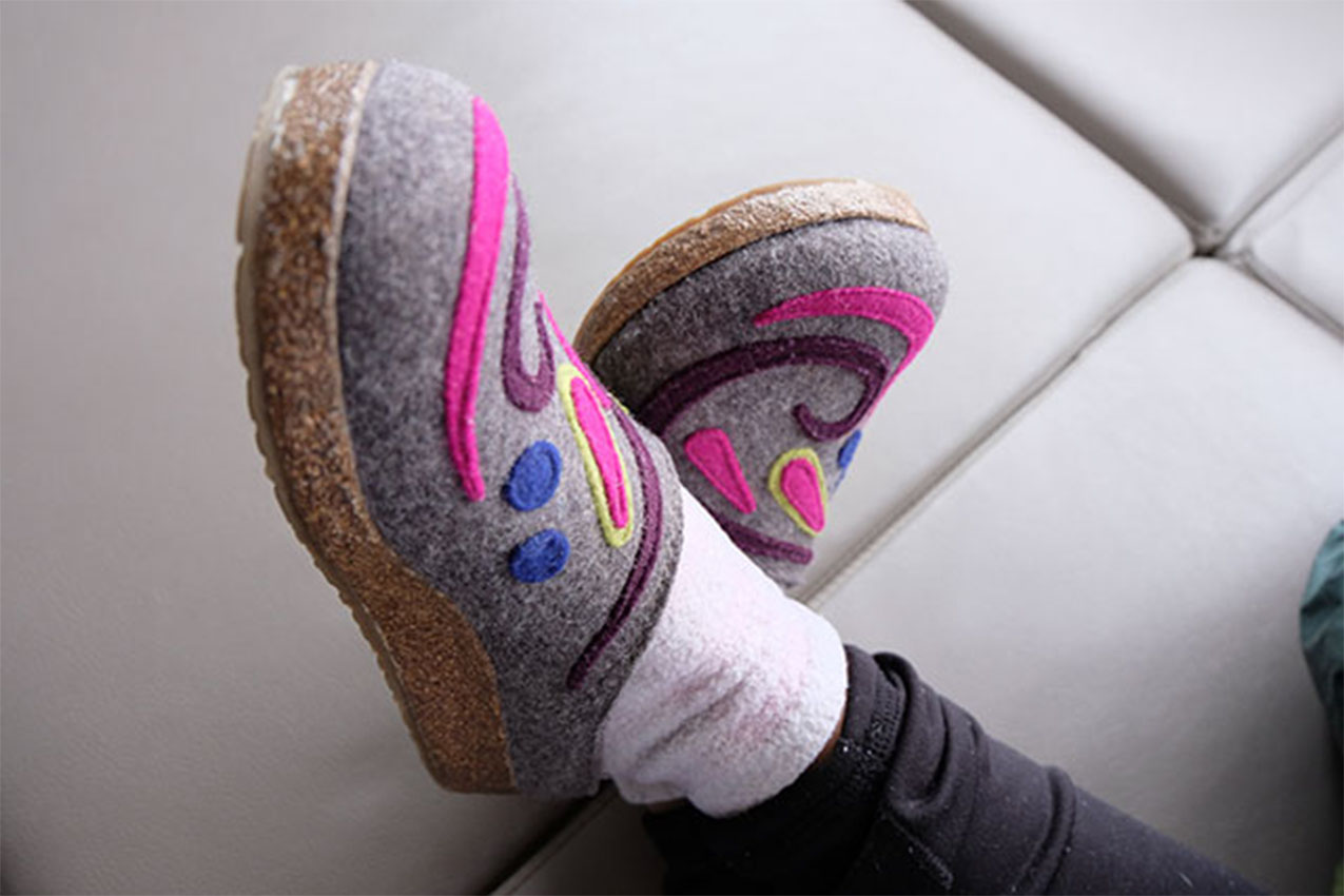 A pair of slippers being worn.
