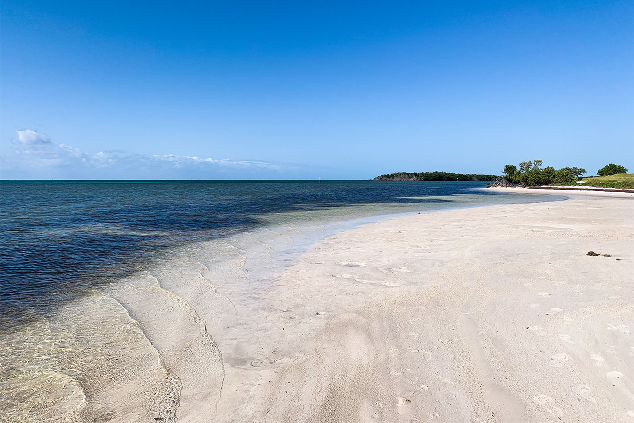White sandy beach and blue ocean.