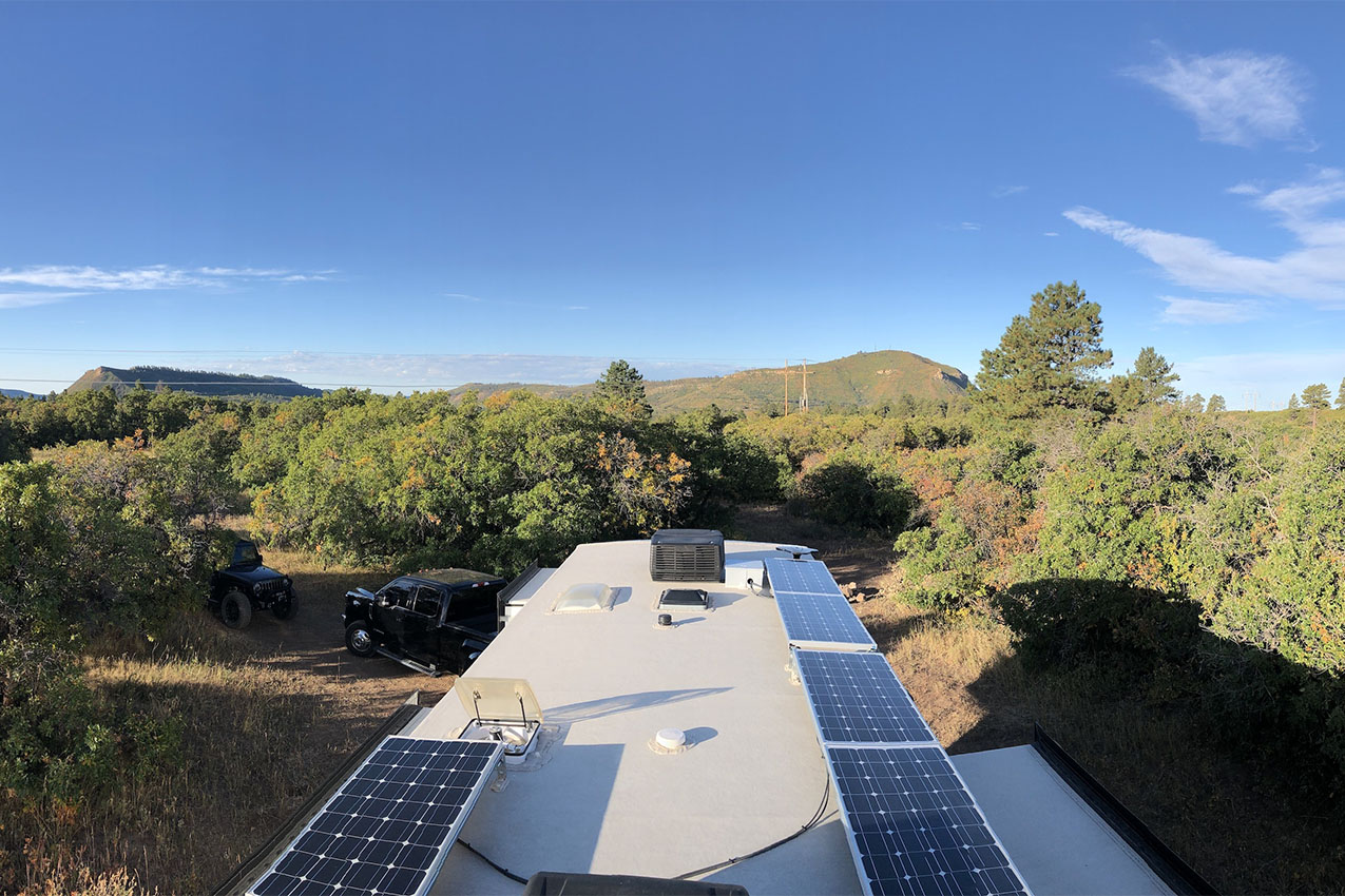 Several solar panels on the roof of an RV.