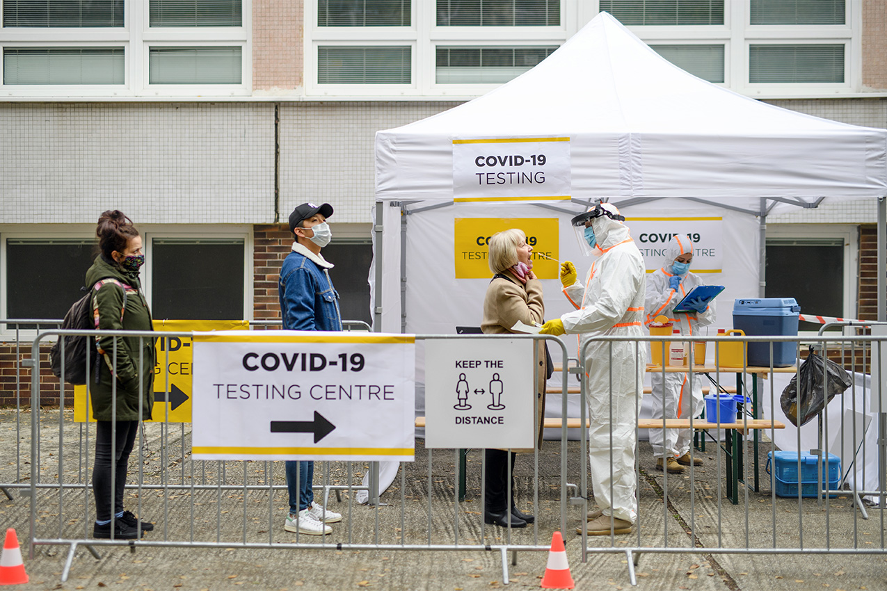 People waiting in line to get Covid-19 test outside on stree.