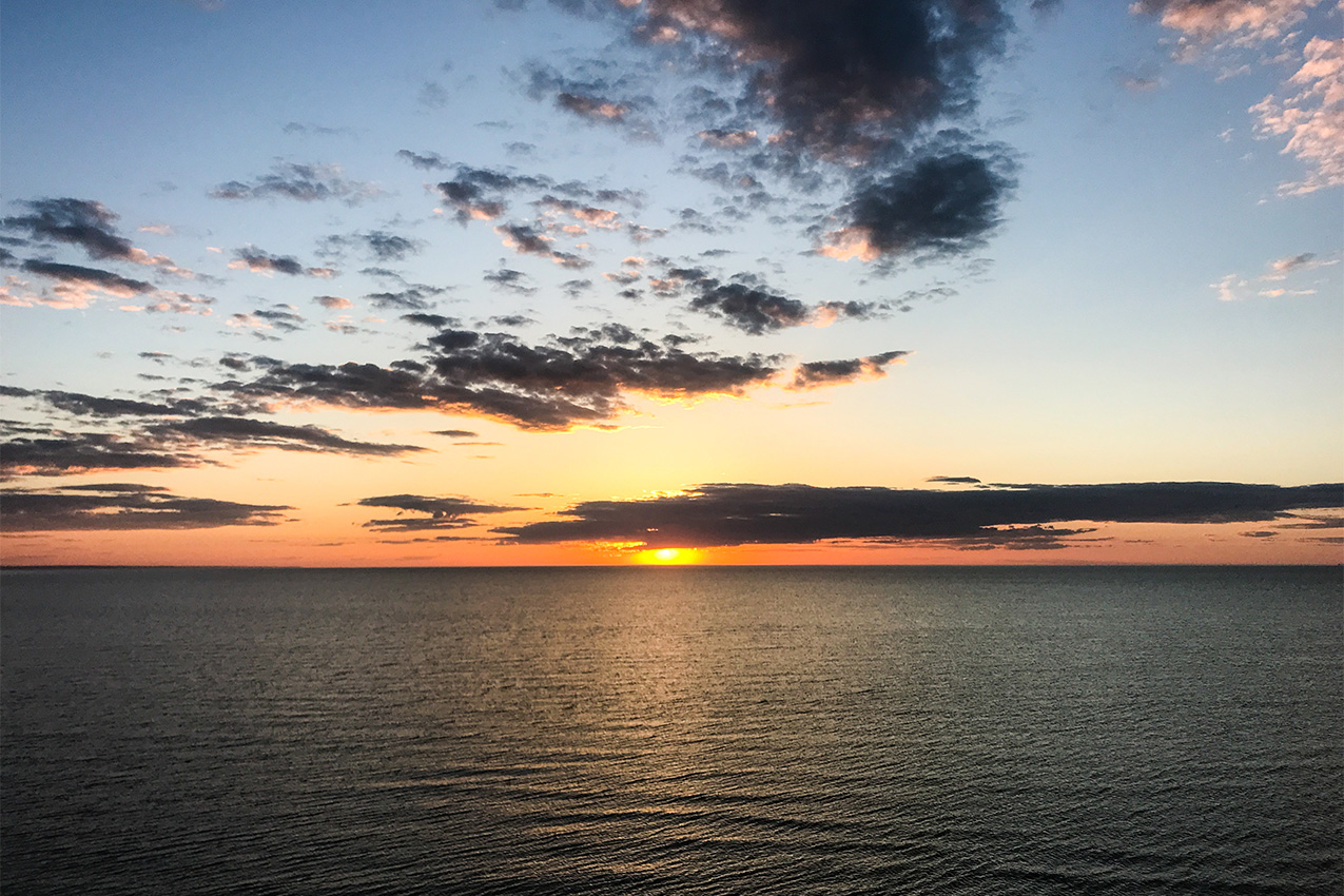 Sun setting on the ocean.