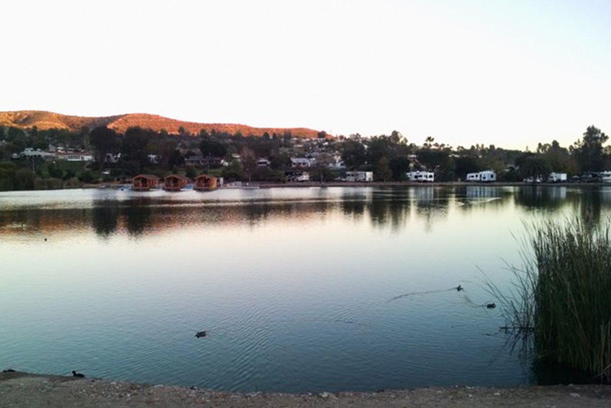 Lake with cabins and RVs along the far side of the shore.