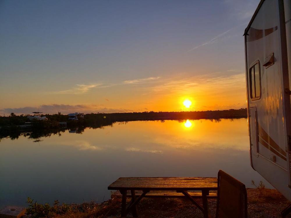 Sunset over lake with RV in view