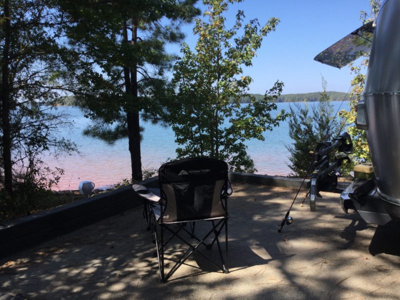 Camp folding chair overlooking lake view