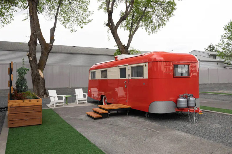 Stationary red travel trailer in parking lot