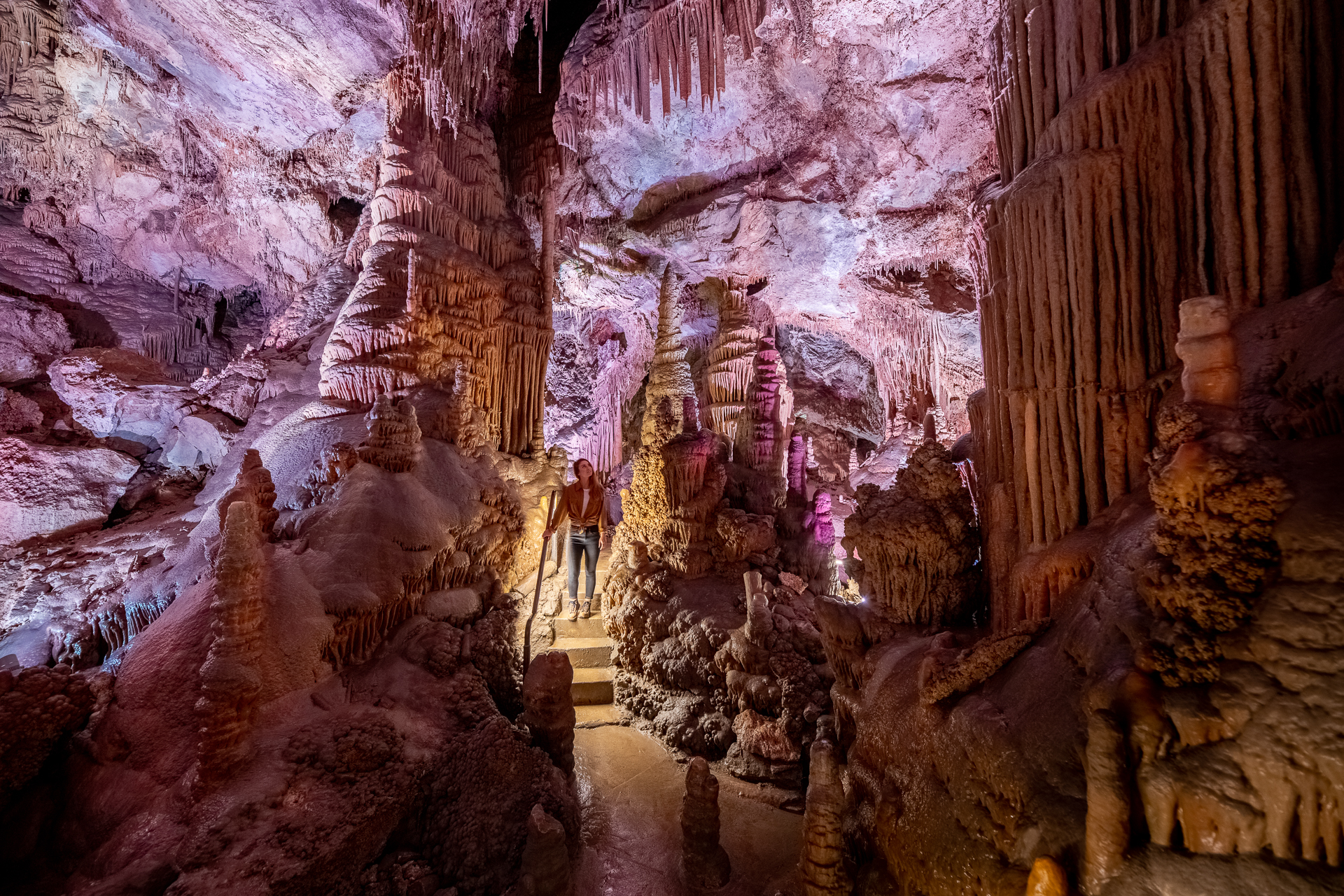 The interior of a cave with towering rock formations in vivid colors