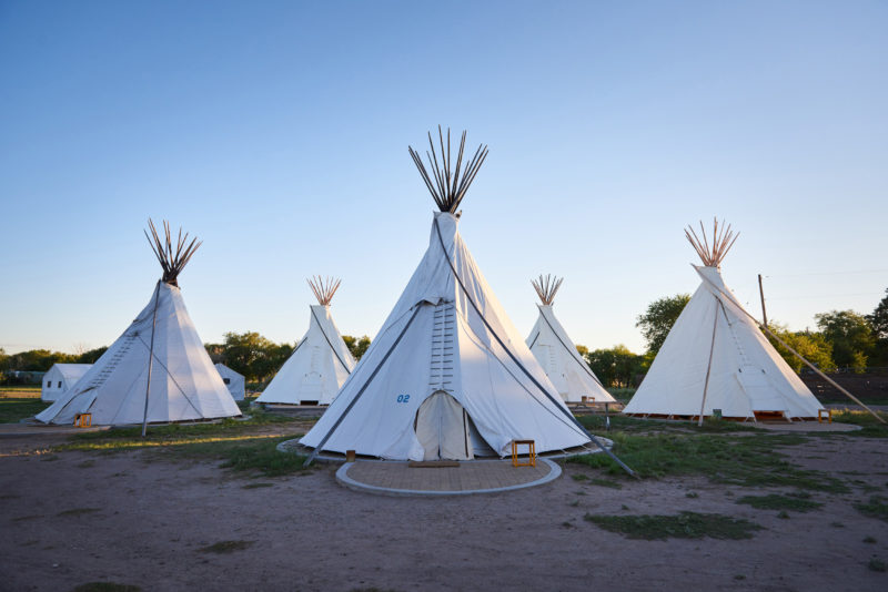 Multiple teepees used for camping at El Cosmic.
