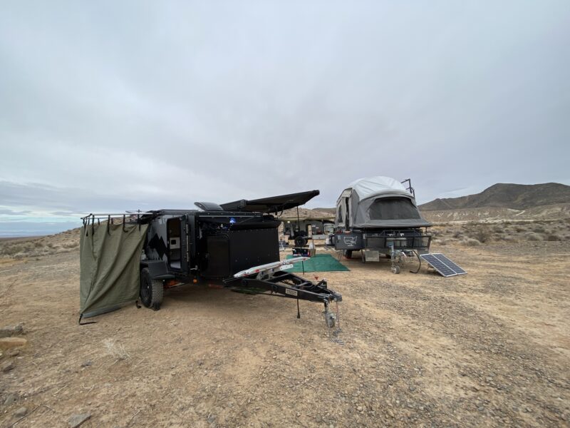 An overlanding RV set up in a remote campsite