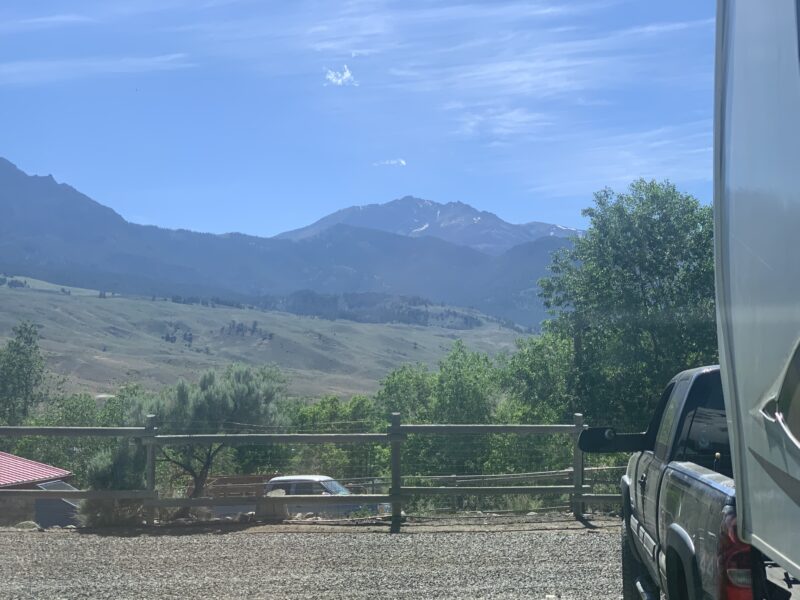 RV parked at a campsite with mountains in the background near Yellowstone National Park