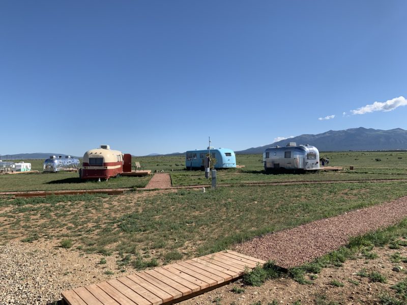 Travel trailers at a campground for glamping