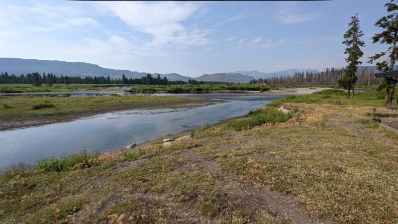 Open field with a stream at a boondocking campground in Wyoming