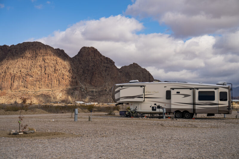 A large fifth wheel RV parked at a campground in Texas