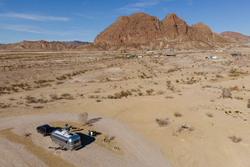 An Airstream RV parked at a spacious campsite in Texas in the desert