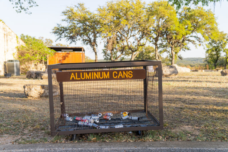 Aluminum can recycling bin outside at a park