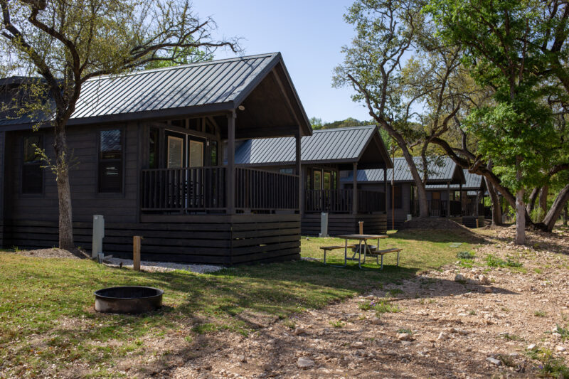 several cabins next to a dry river bed