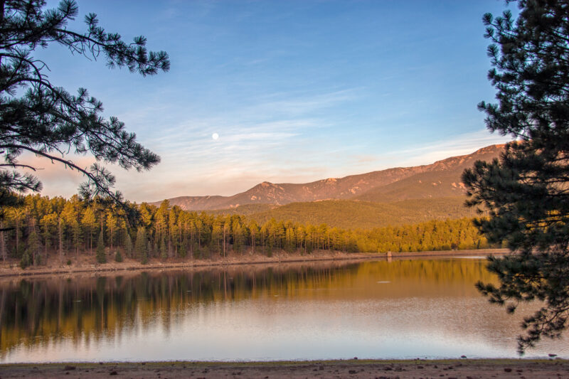 a lake surrounded by trees and mountains