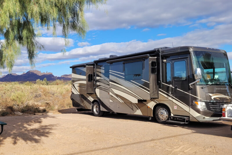 a large rv is parked at a campsite