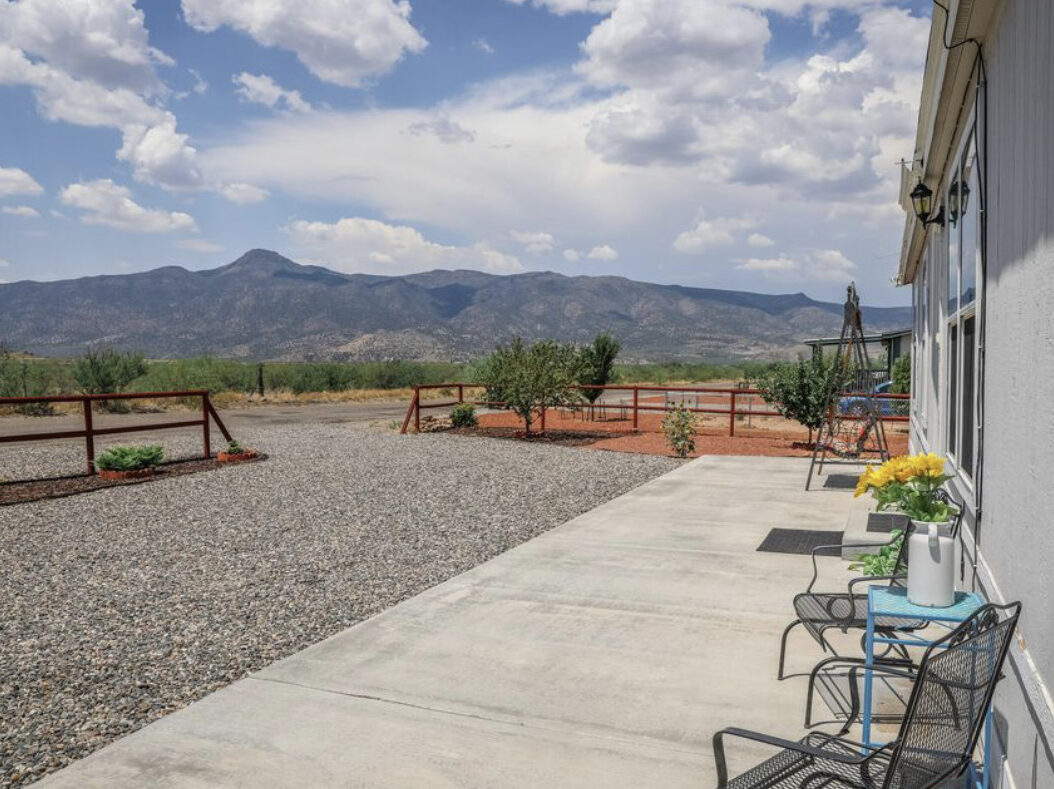 gravel rv pad next to cement patio with a chair