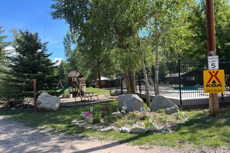 a campsite with a red and yellow sign for KOA holiday