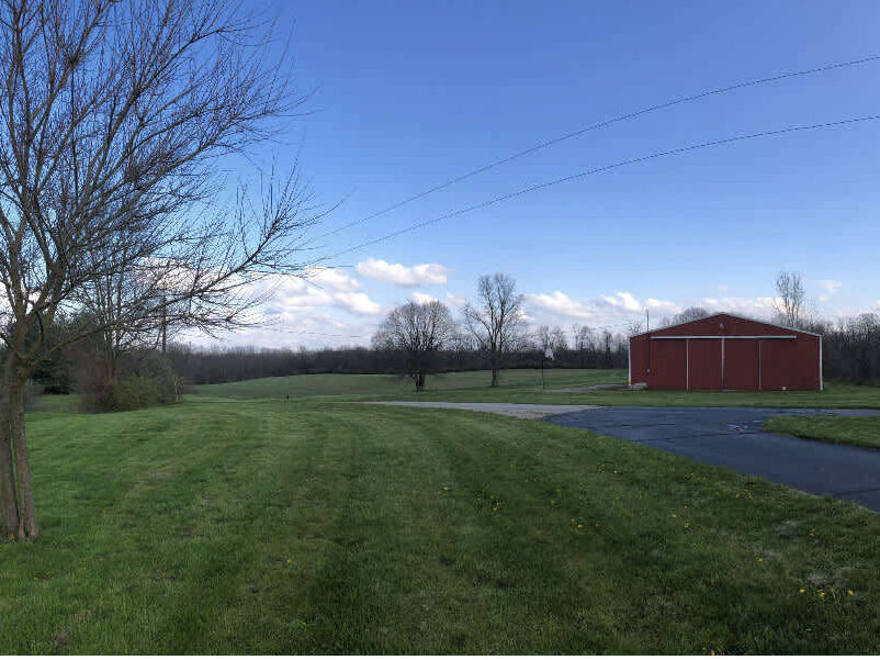 Green grass and a red barn