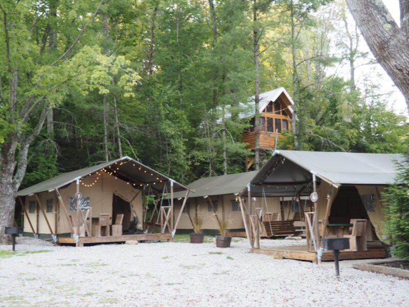 Large family-size tents sit together at a glamping resort.
