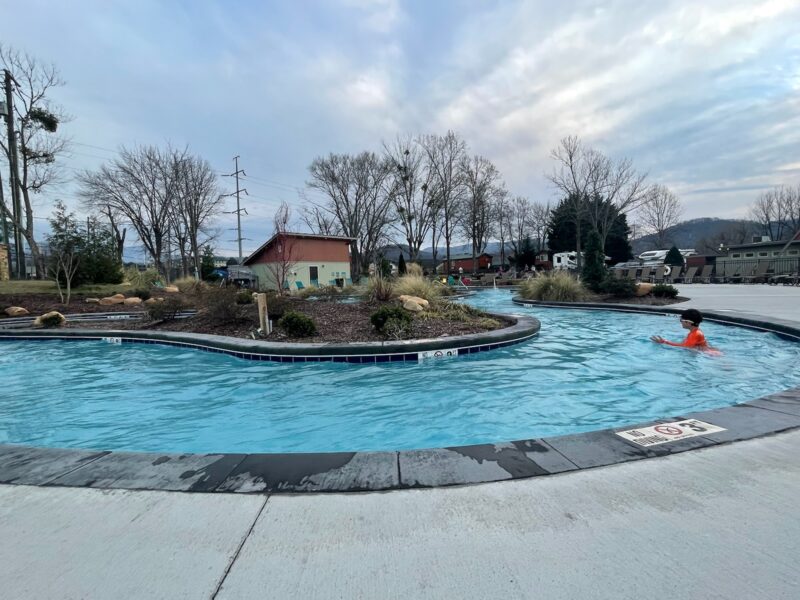A child swims in a winding lazy river at the Pigeon Forge KOA campground.