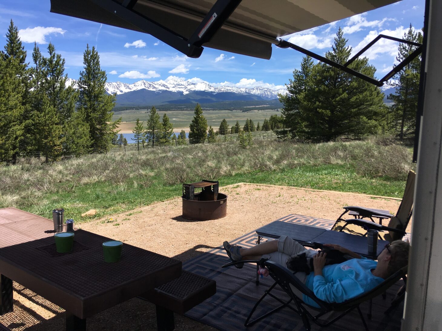 An RV camper overlooks a mountain range in the distance