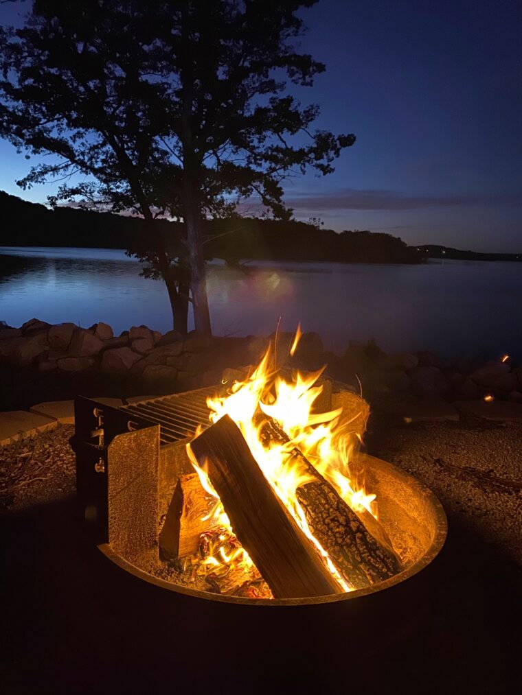 A well-controlled campfire illuminates an otherwise dark nighttime landscape