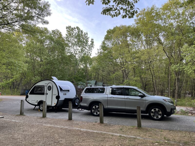 Pickup truck towing a teardrop trailer at Indiana Dunes National Park