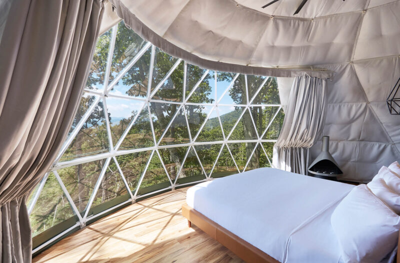 Interior of a luxury glamping dome with mountaintop views