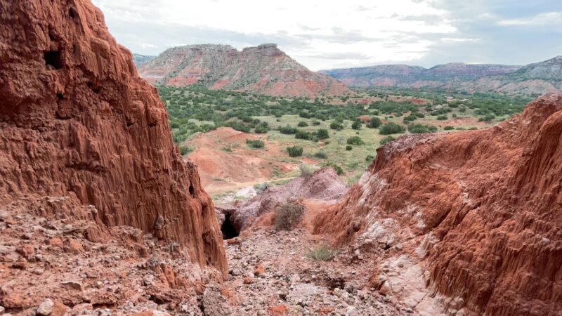 Red rocks and green grasses define the landscape at Palo Duro Canyon