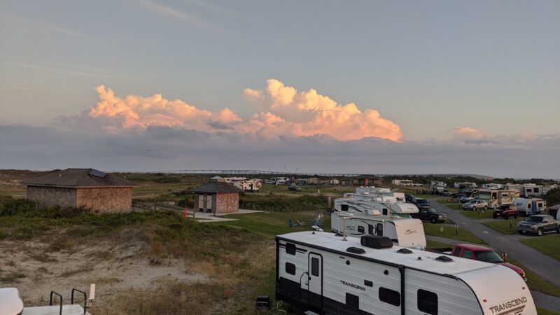 RVs parked at a sandy campground